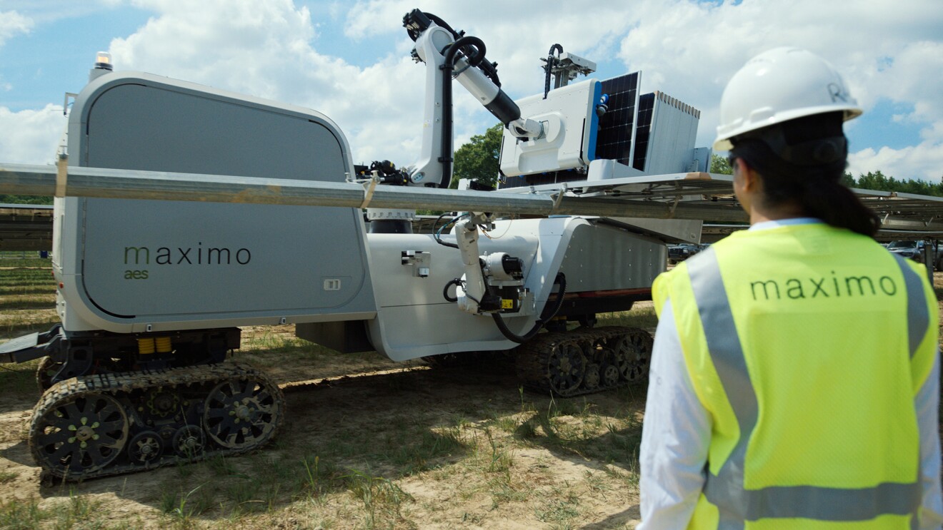 Overhead shot of workers at a solar power station working with AI-powered robot