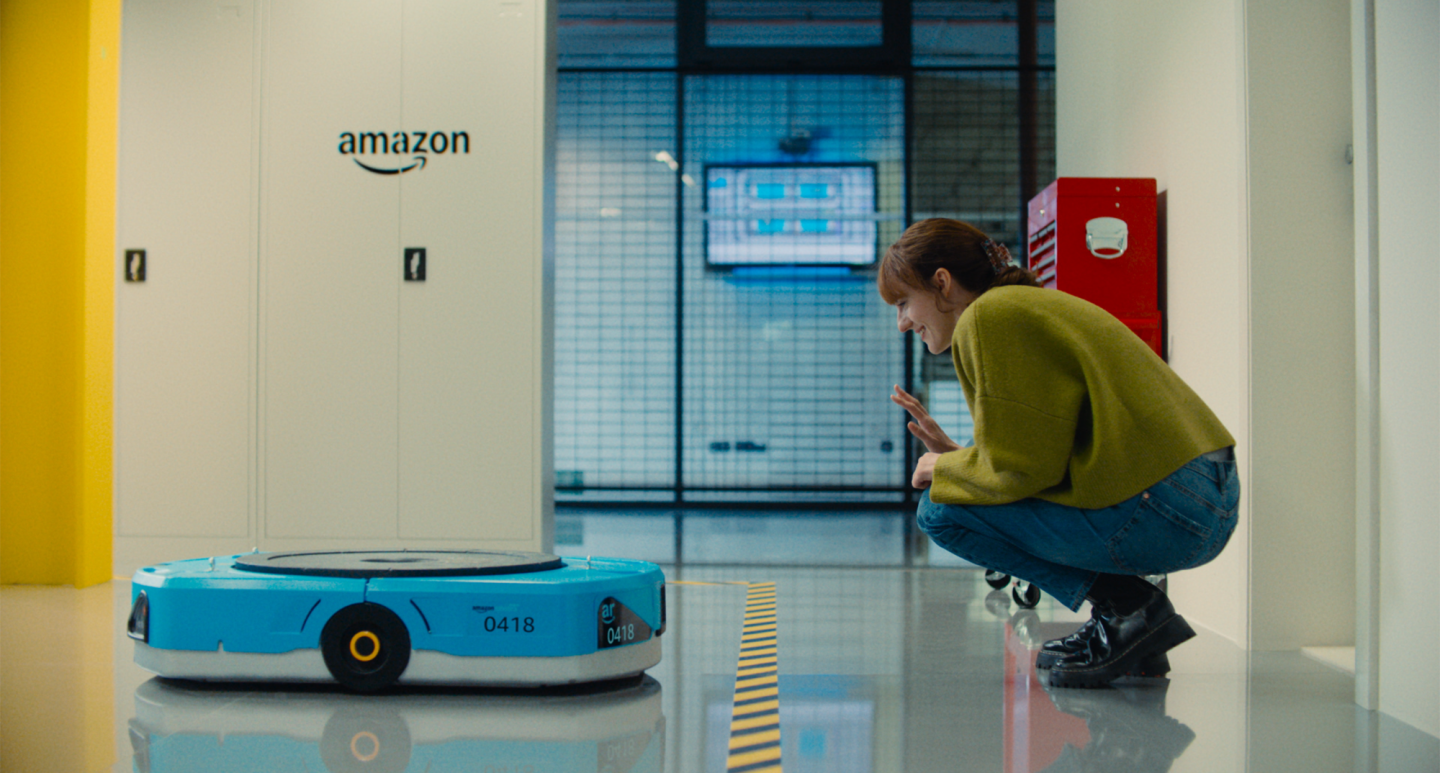 Woman waving to a transport robot