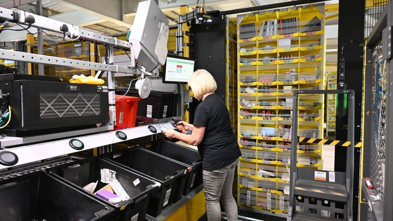 An employee moving products into the moving pods in the fulfilment centre