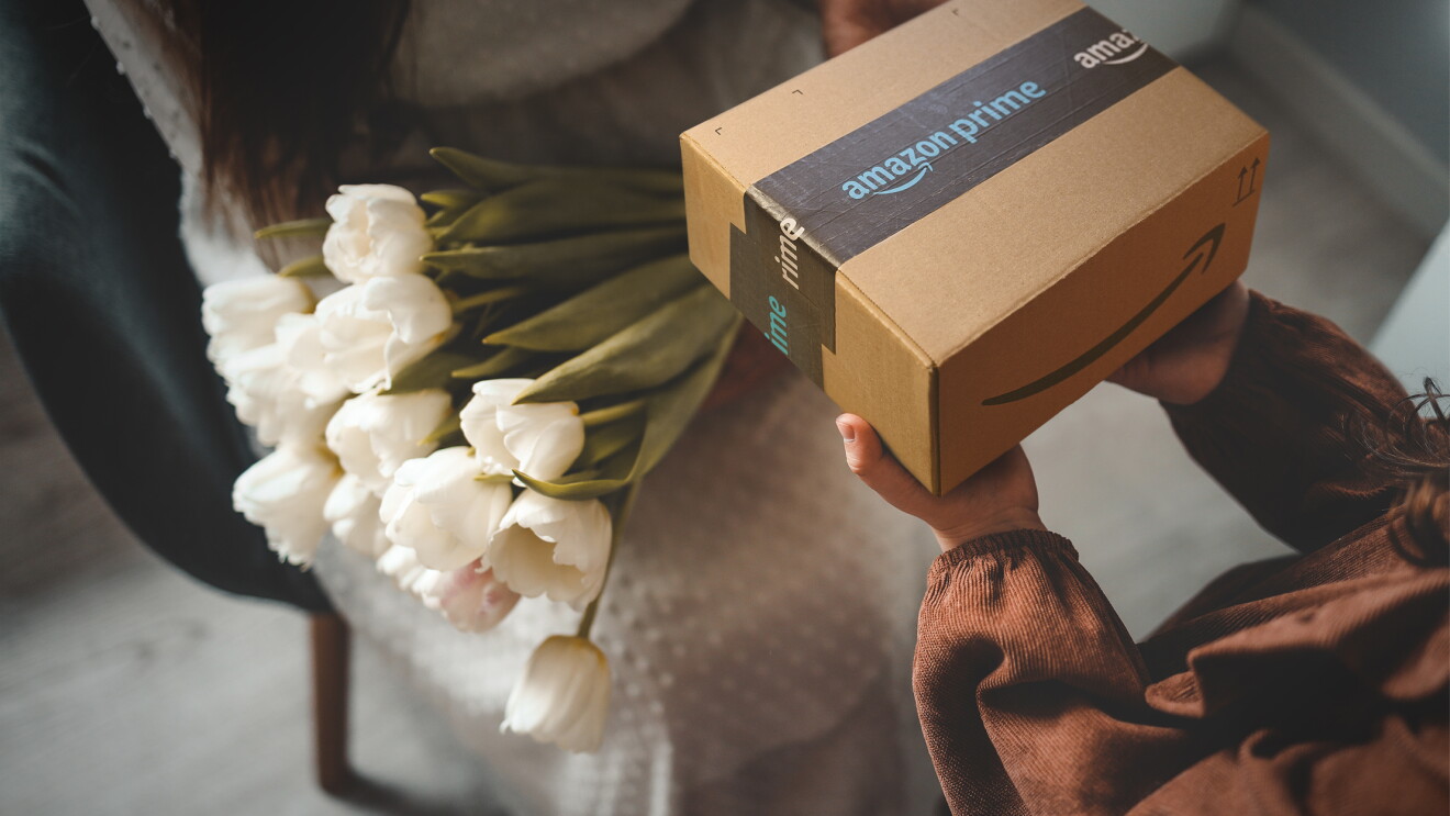 An Amazon package is given to a woman