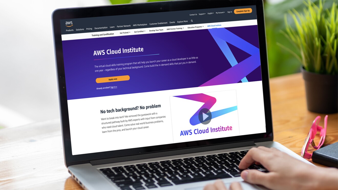 A photo of a laptop device that displays AWS Cloud Institute on the home screen.