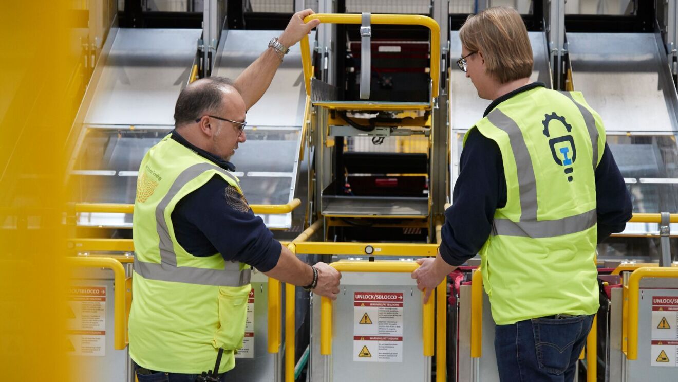 Two Amazon employees review the machines at the innovation lab.