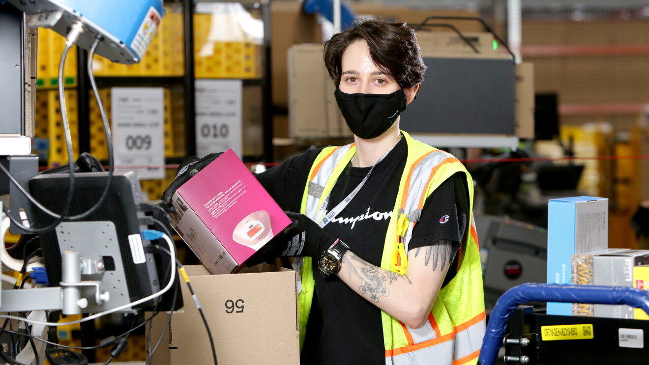 Amanda packs a box at Amazon's Brisbane fulfilment centre