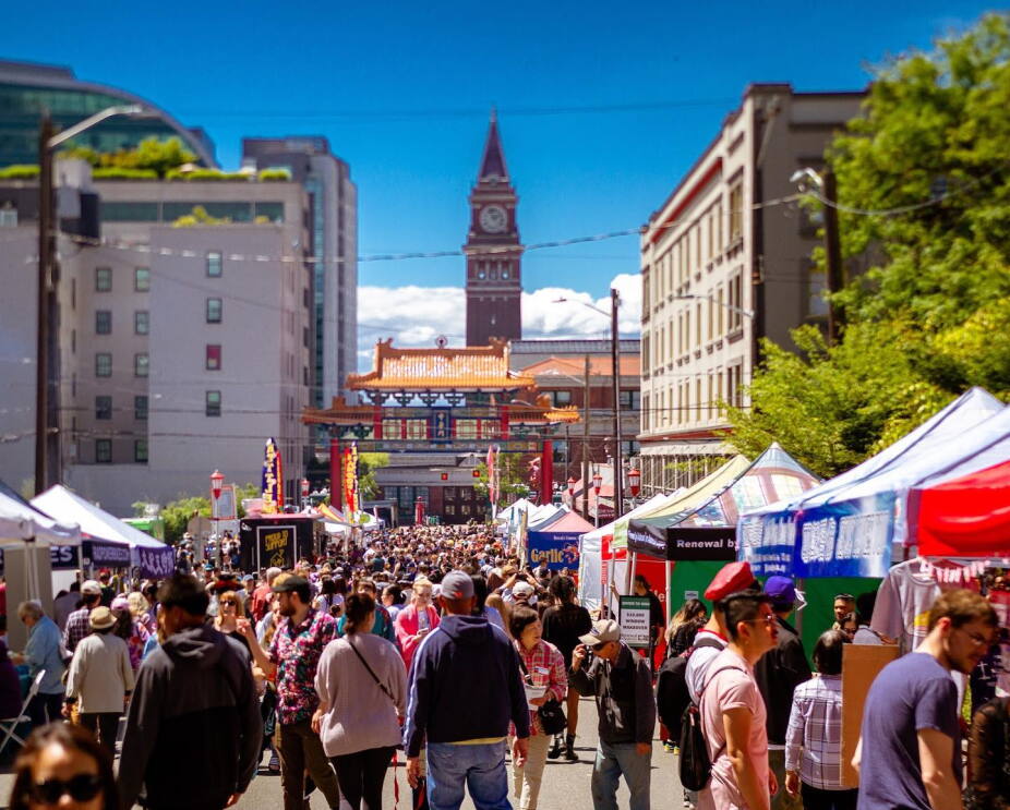Individuals walking around the annual Night Market in Seattle's historic Chinatown-International District