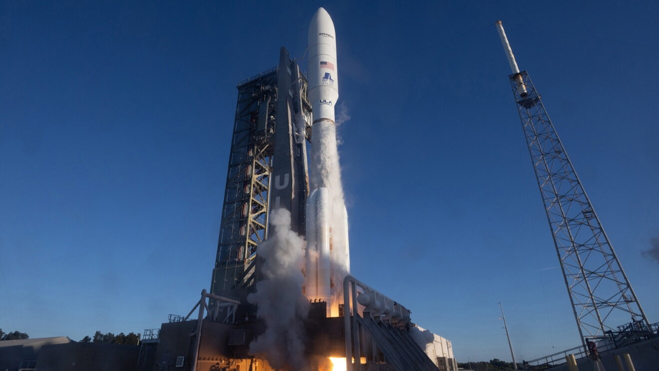 Space launch vehicle igniting engines on launchpad