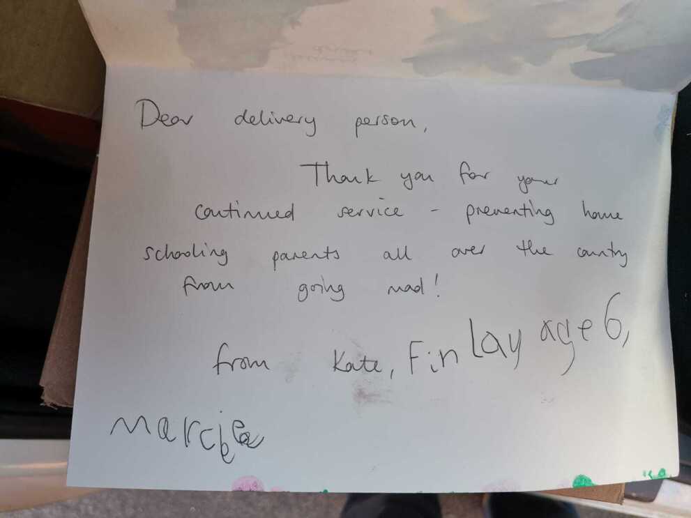 A handwritten thank you note to an Amazon delivery driver signed by two young children.