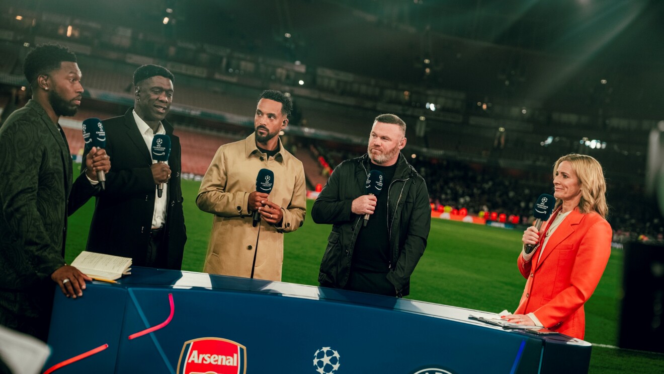 Sports commentators including Wayne Rooney and Gabby Logan at a Champions League match between Arsenal and Paris Saint-Germain