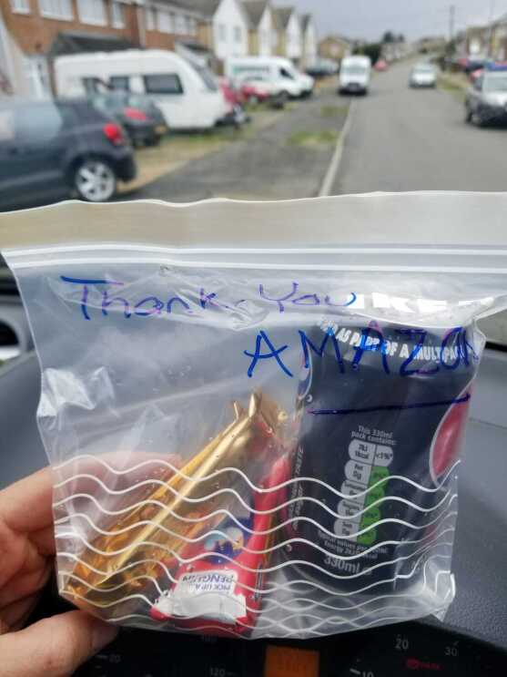 A zip lock back with a drink and snacks in it for an Amazon delivery driver. The bag has 'Thank you Amazon' written on it.