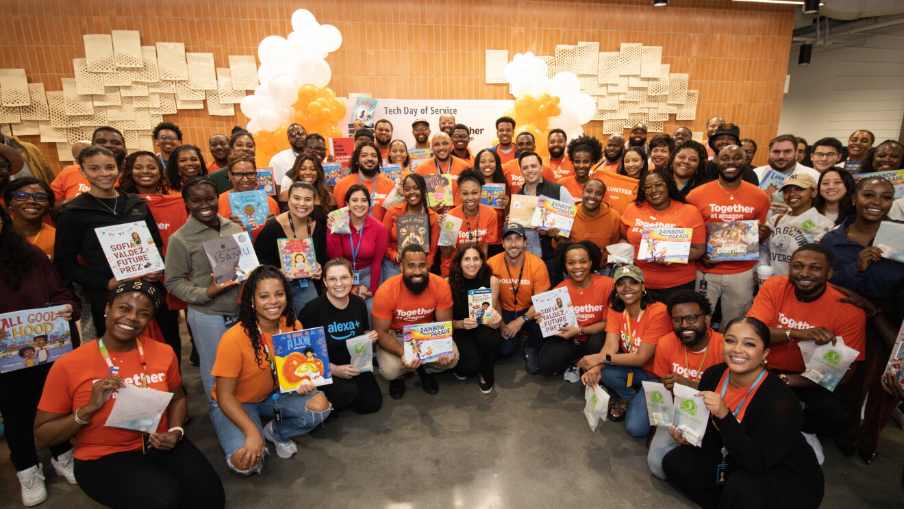 BEN-DMV group posing with books for Tech Day of Service event