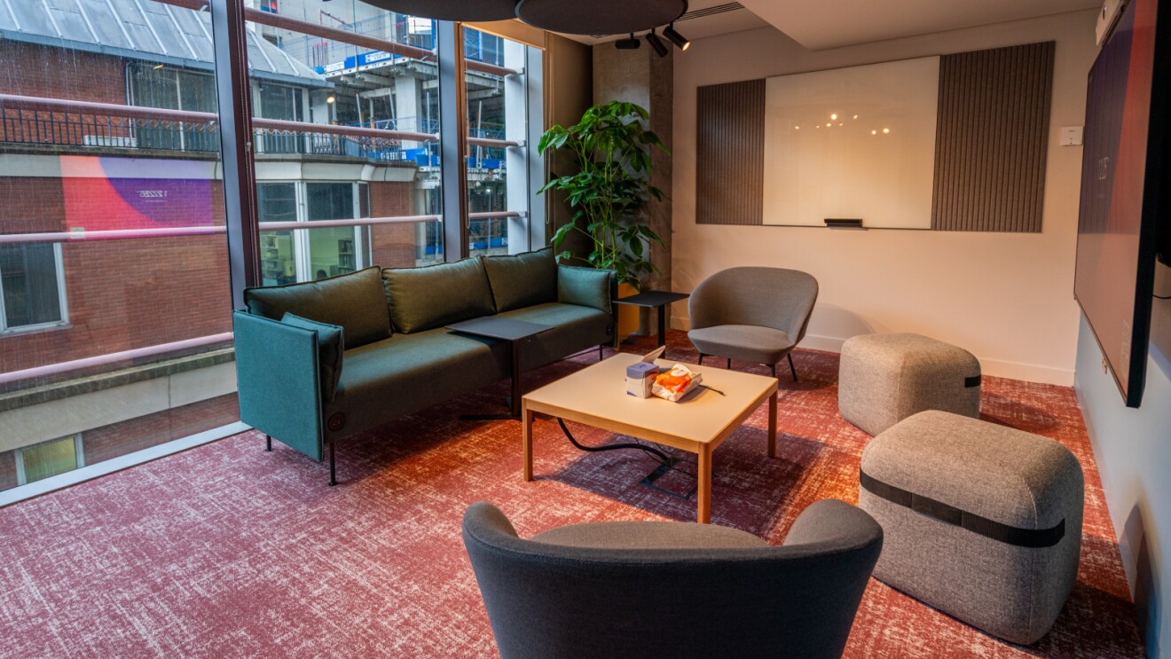 Modern office lounge with colorful carpet and city view