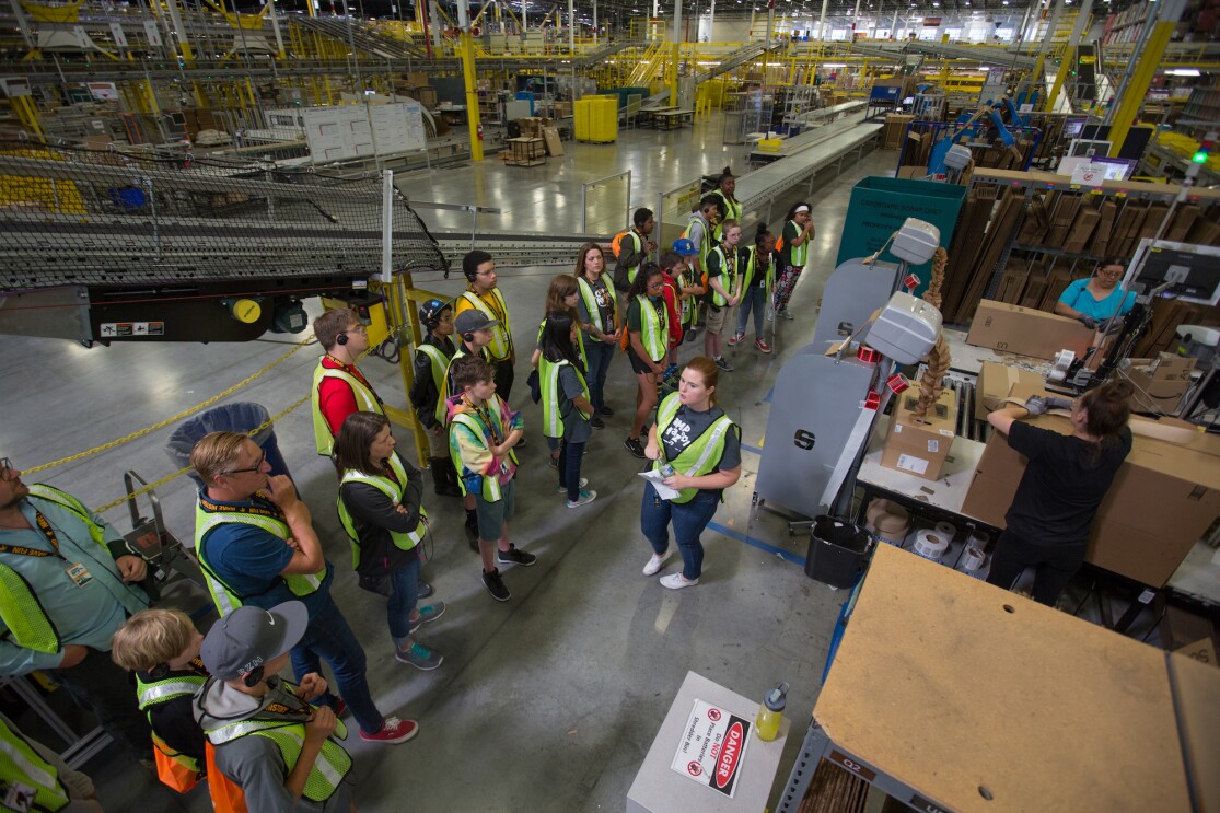 Students participate in a Camp Amazon event at a fulfillment center in Washington