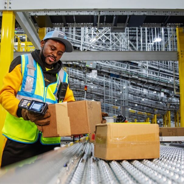 portraits and environmental photos of abel tuyisenge, a transportation operations management associate at amazon, as he drives and inspects trucks