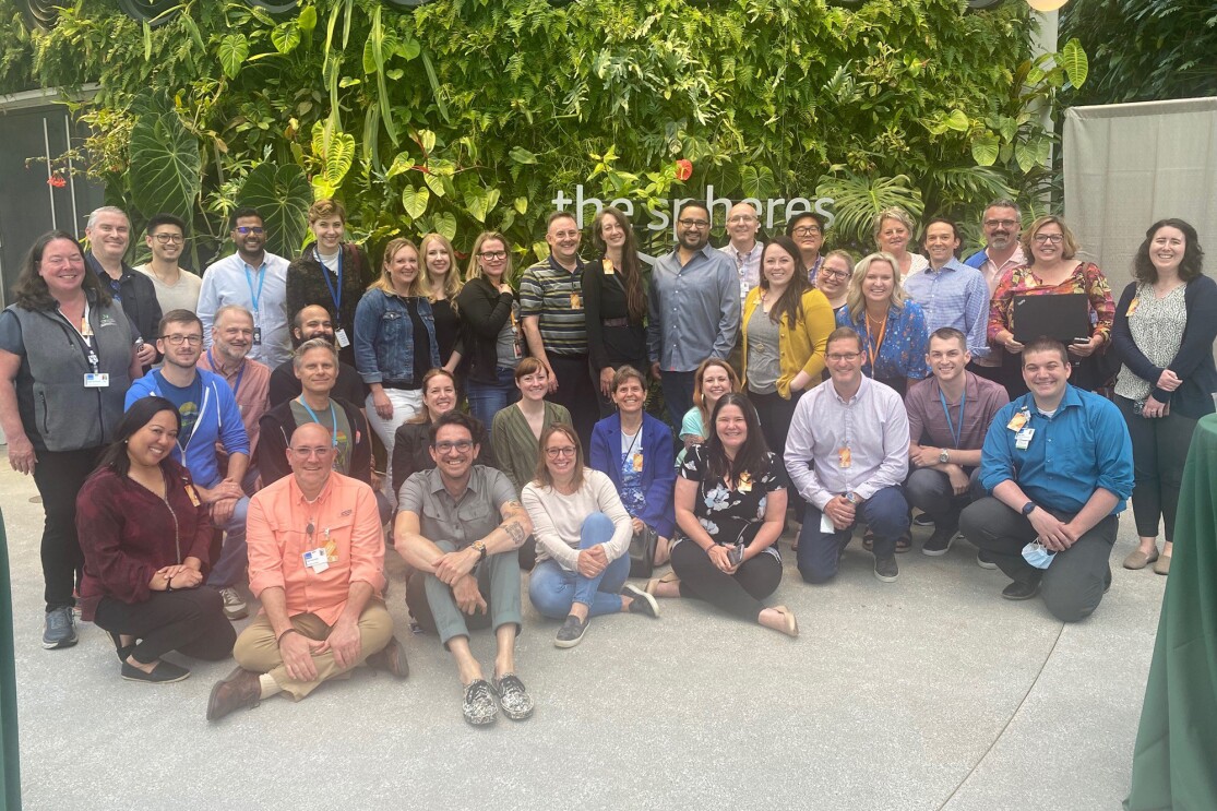 A group of a few dozen individuals inside of the Amazon Spheres