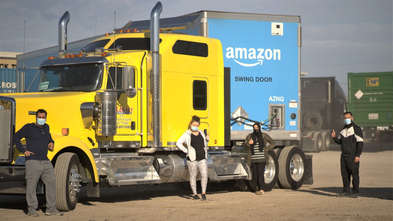 Amazon employees who work on the middle mile, posing for the camera at work