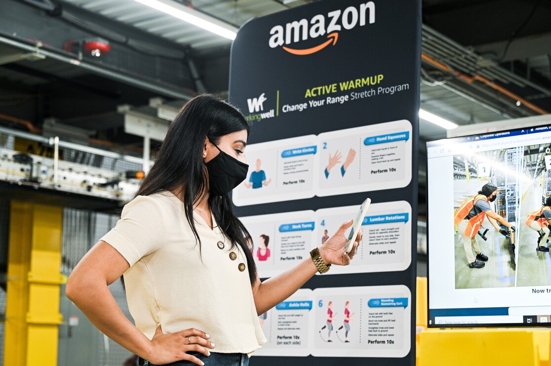 An image of an Amazon employee in a fulfillment center demonstrating how WorkingWell works.
