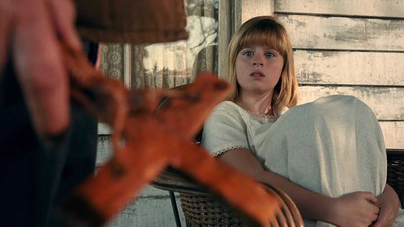 The Conjuring movie: Young girl with concerned expression sitting near window