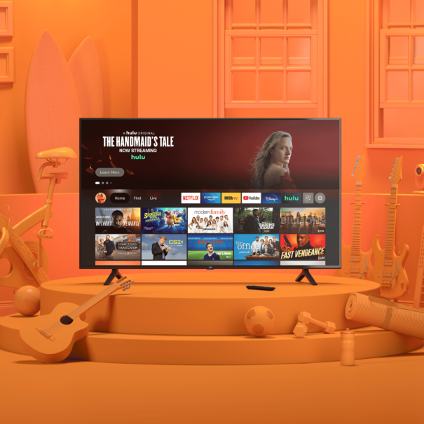 TV displaying streaming services in orange-themed room with exercise bike and guitar

