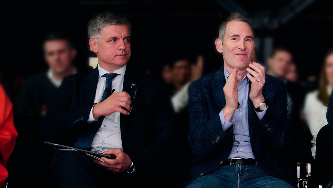 Ukraine’s Ambassador to the UK Vadym Prystaiko sits next to Andy Jassy in the audience of the all-hands company meeting in London. Andy Jassy smiles and claps as Prystaiko grabs his glasses from his pocket and is called to the stage.