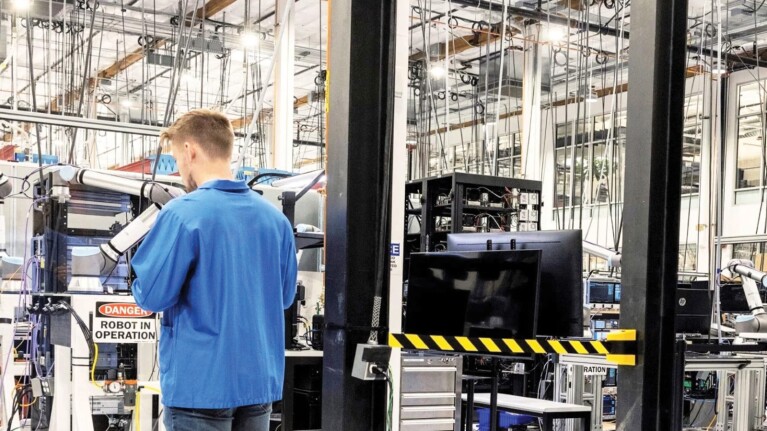 An image of an Amazon employee working at the Project Kuiper factory.