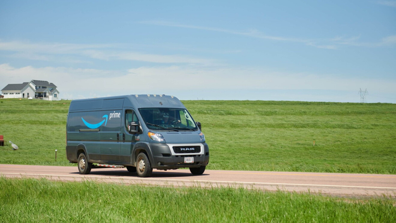 Amazon Prime delivery van on rural road with farmhouse in background