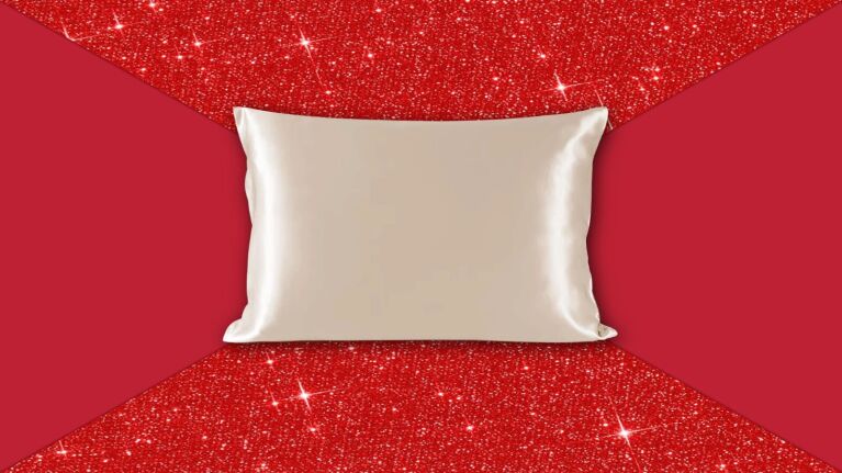 White silk pillow on glittery red background