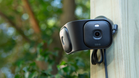 Blink Arc, dual security cameras mounted on a wooden post in an outdoor setting