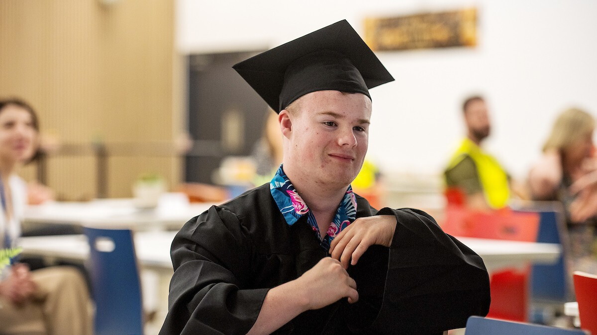 Rhys Cole Supported Internship Graduation, wearing a cap and gown