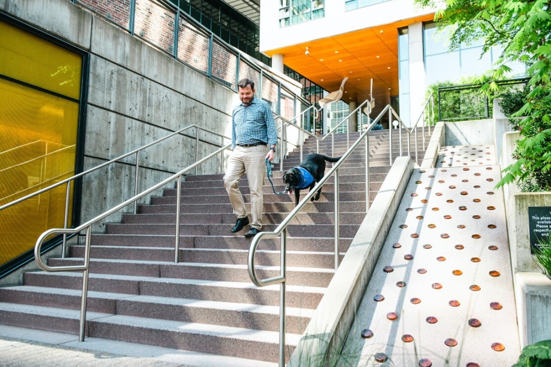 Chris and Sadie walk down the stairs outside of Amazon's hedquarters.