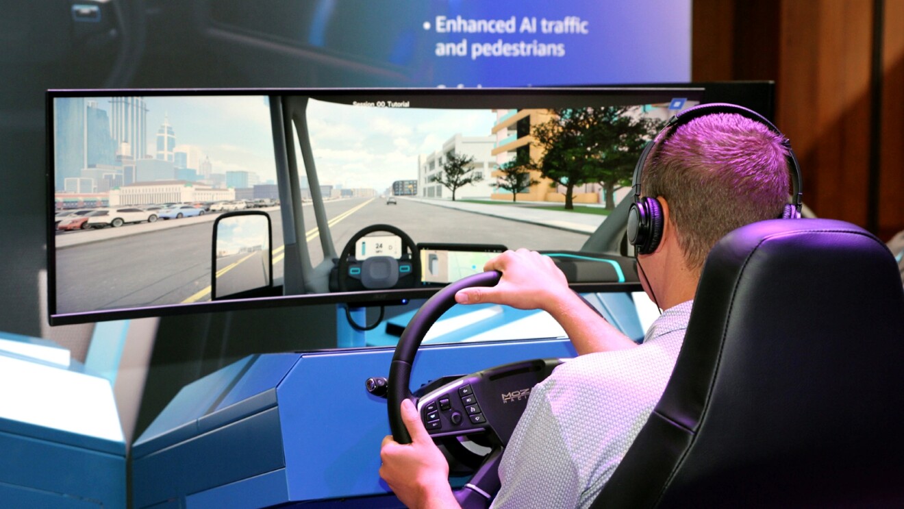 Driver using AI-enhanced traffic simulator with large screen display