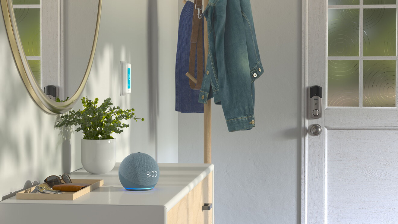 An image of an Alexa-enabled device sitting on a table in the entryway of a home.