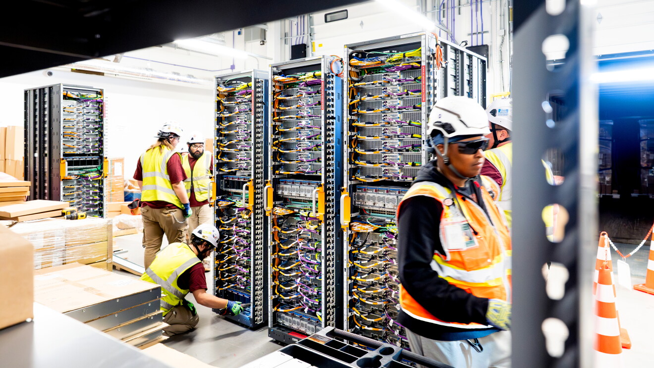 Amazon data center staff performing maintenance on server equipment