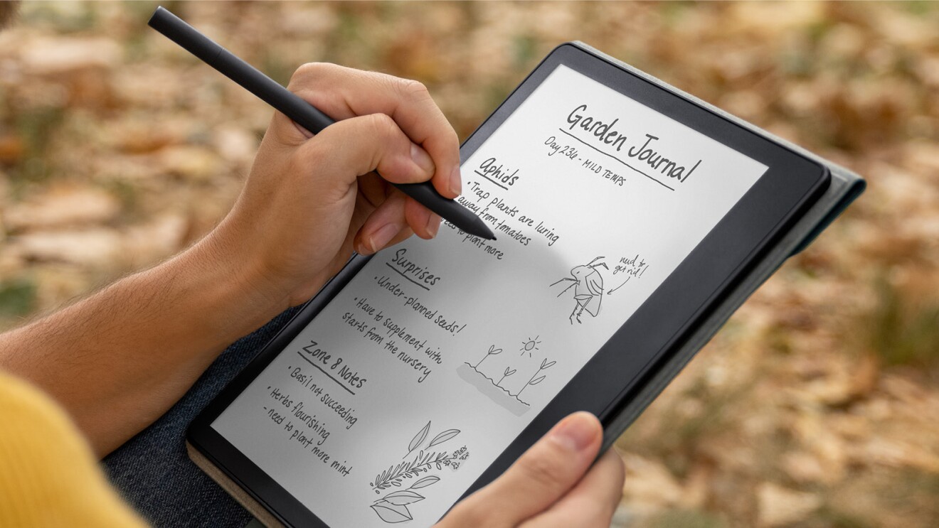 A close-up of a left-handed person writing a Garden Journal on their Kindle Scribe. 