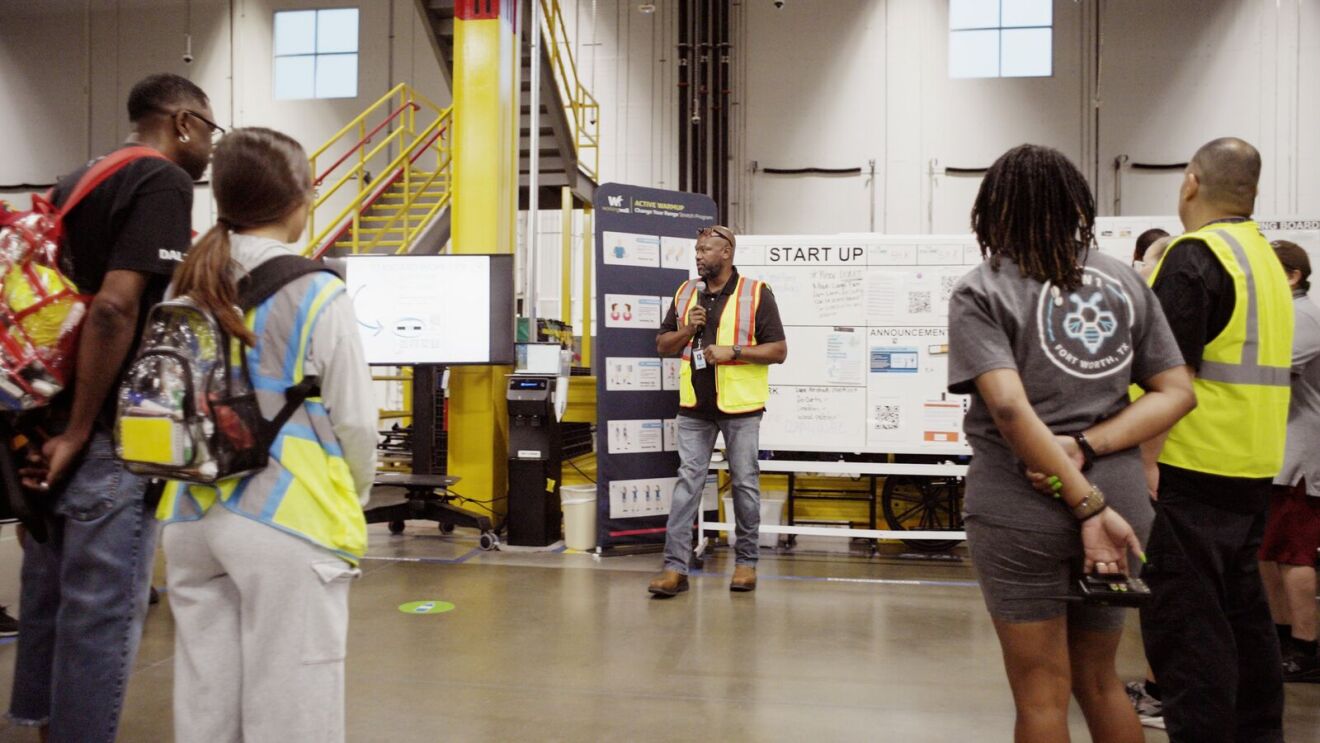Employees gathered for startup briefing in Amazon workspace