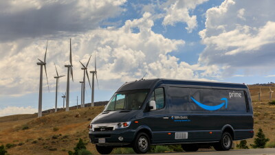  An Amazon truck drives past wind turbines.