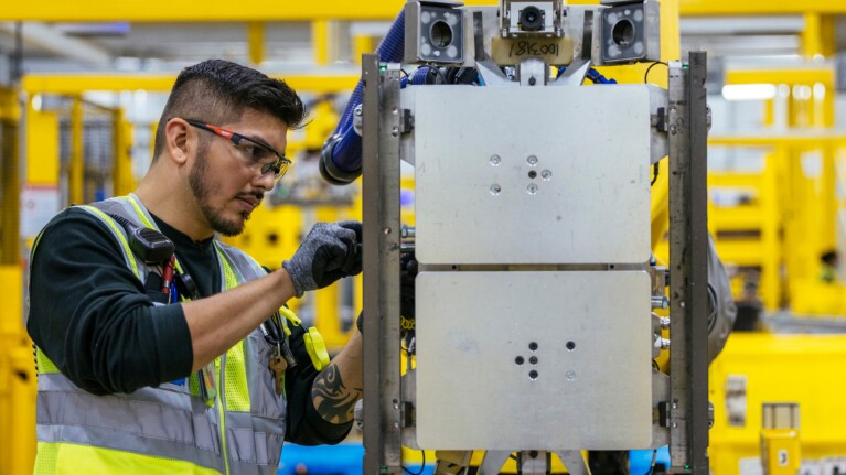 An Amazon employee works in a fulfillment center.