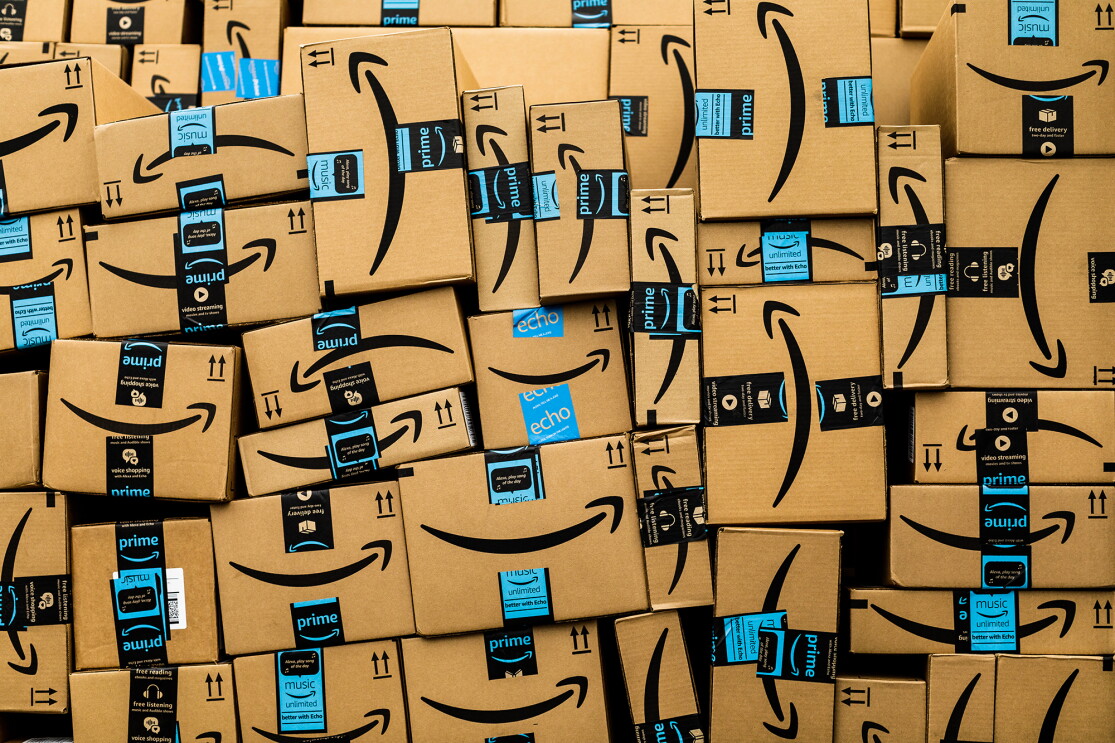Amazon boxes in different shapes and sizes are stacked to fill the entire photo frame. 