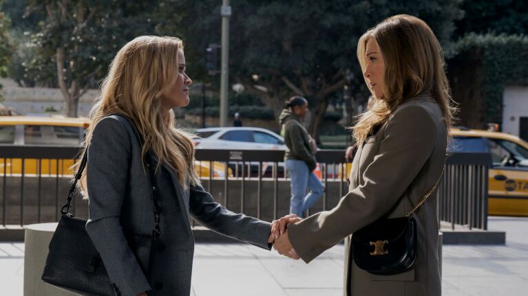 Reece Witherspoon and Jennifer Aniston hold hands on a street in New York