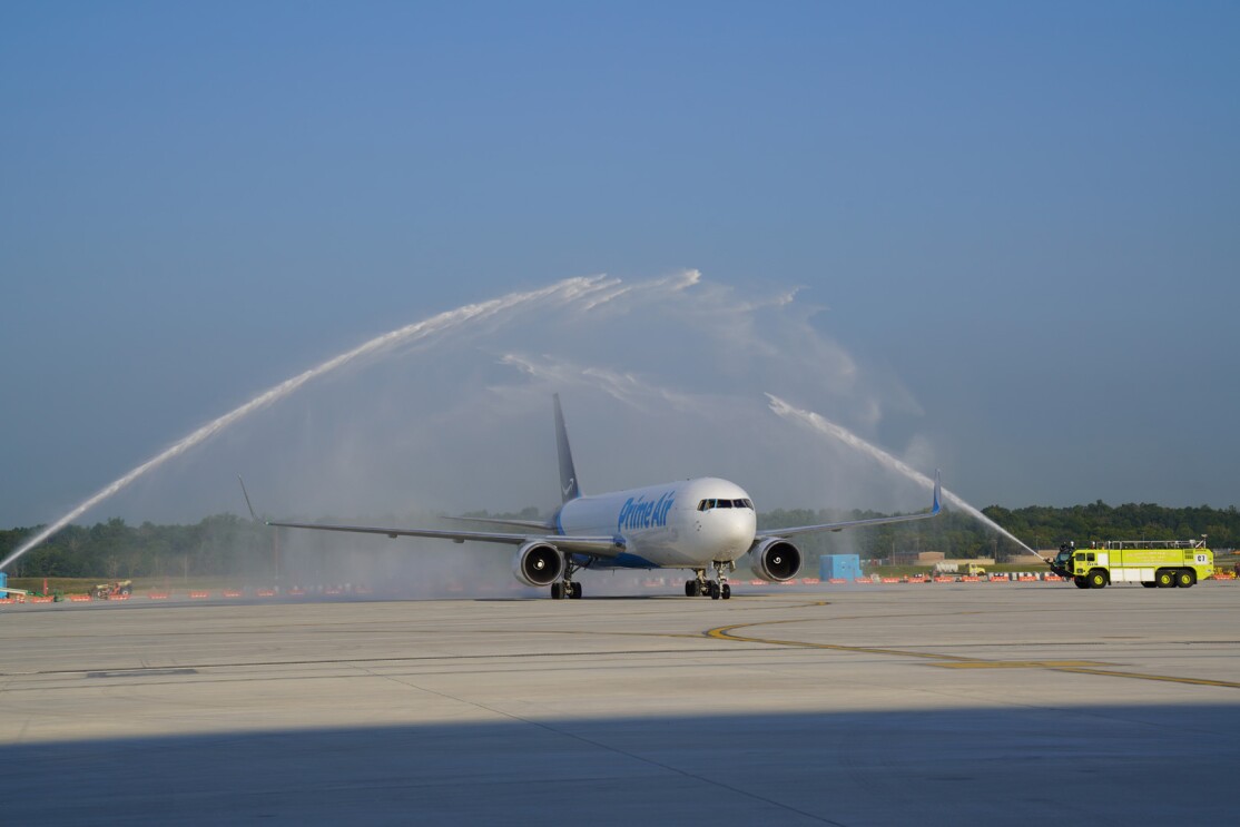 An image of a plane on the runway at the new Air Hub. The plane is being sprayed down with a fluid.