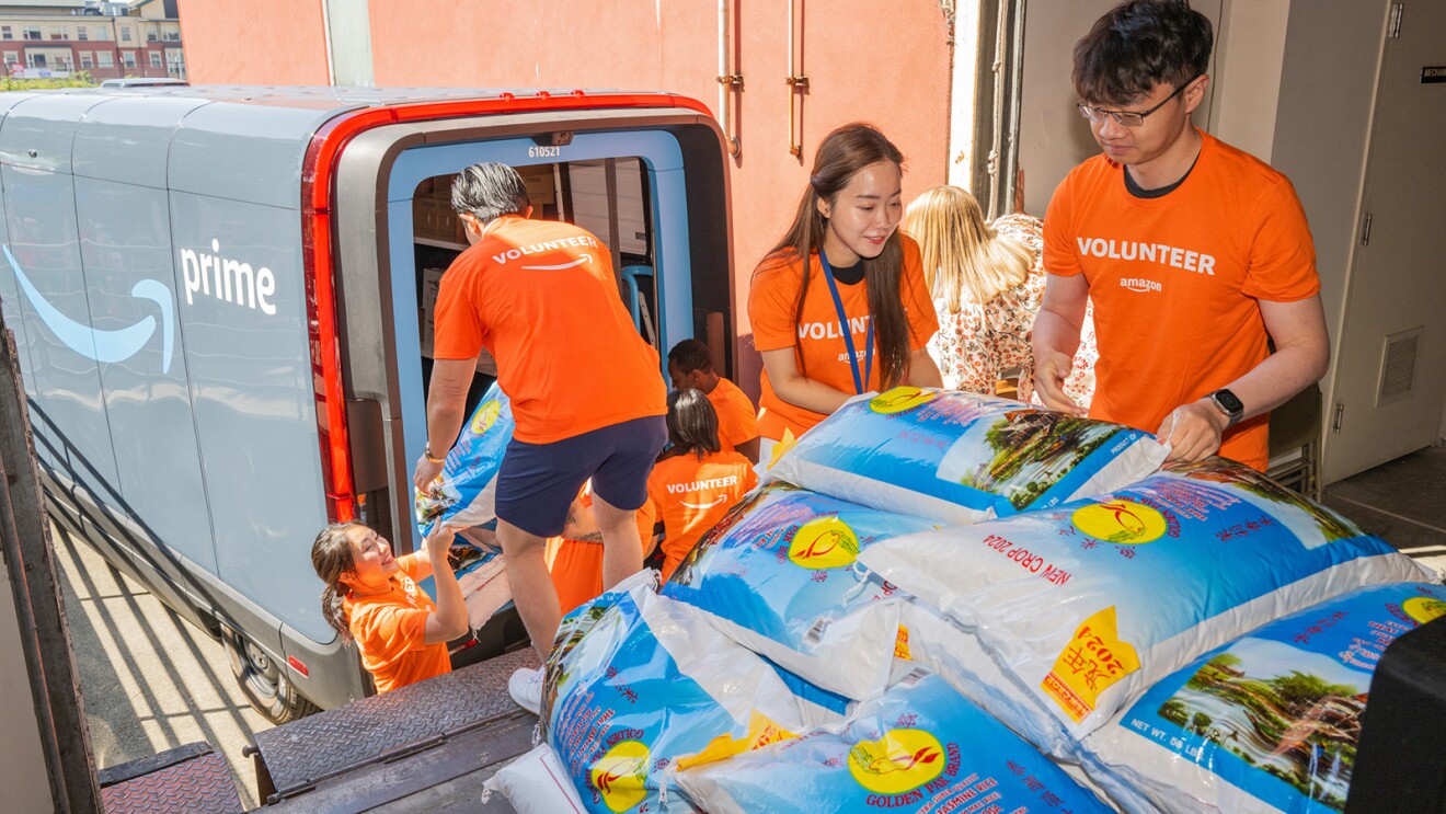 Amazon volunteers unload an Amazon delivery truck full of food donations as part of Bumbershoot Gives Back.
