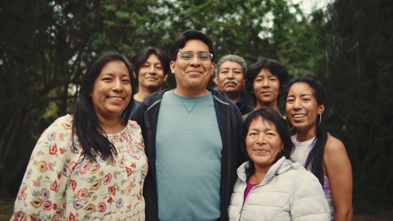 José Tapia, standing in the middle of six other family members outside.