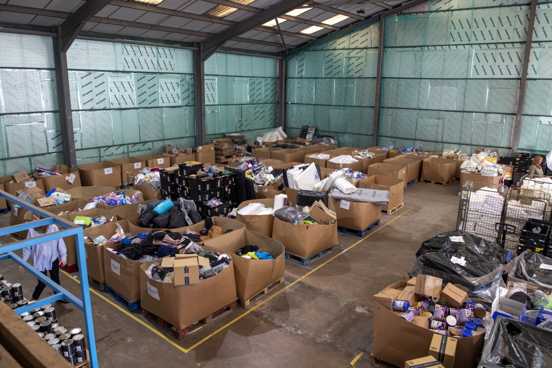 An image of a warehouse with lots of boxes of donations