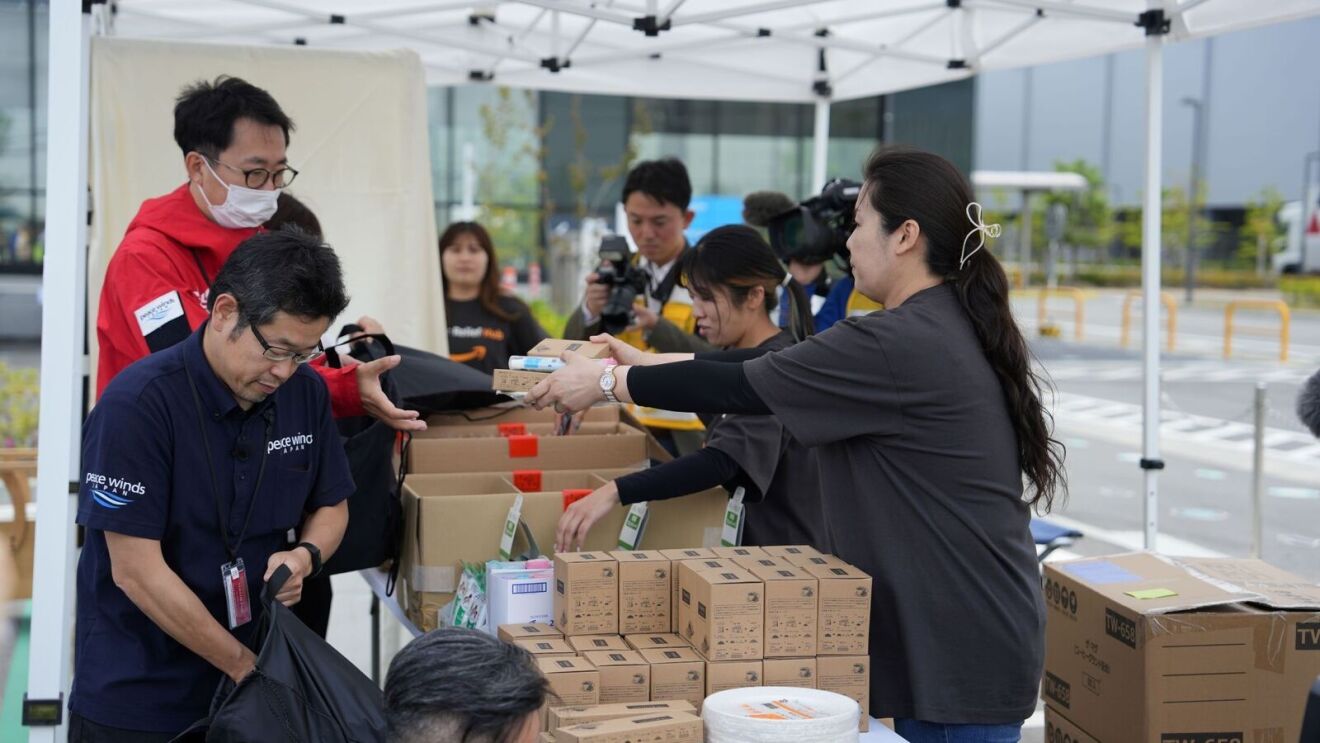 Men and women organizing supplies and relief items to support victims of the earthquake in Japan