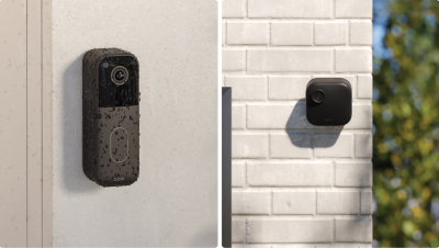 Two smart home security cameras mounted on exterior walls
