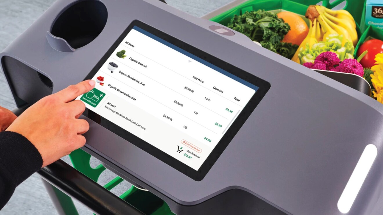 A photo of a customer purchasing goods with Amazon Dash Cart.