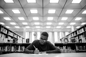 Amazon Future Engineer student studying at a desk in the library.