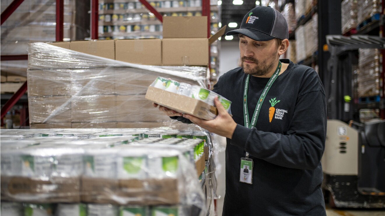 Volunteer at Central Texas Food Bank checking inventory