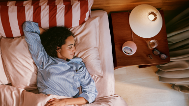 Women in bed looking at Echo Time on nightstand