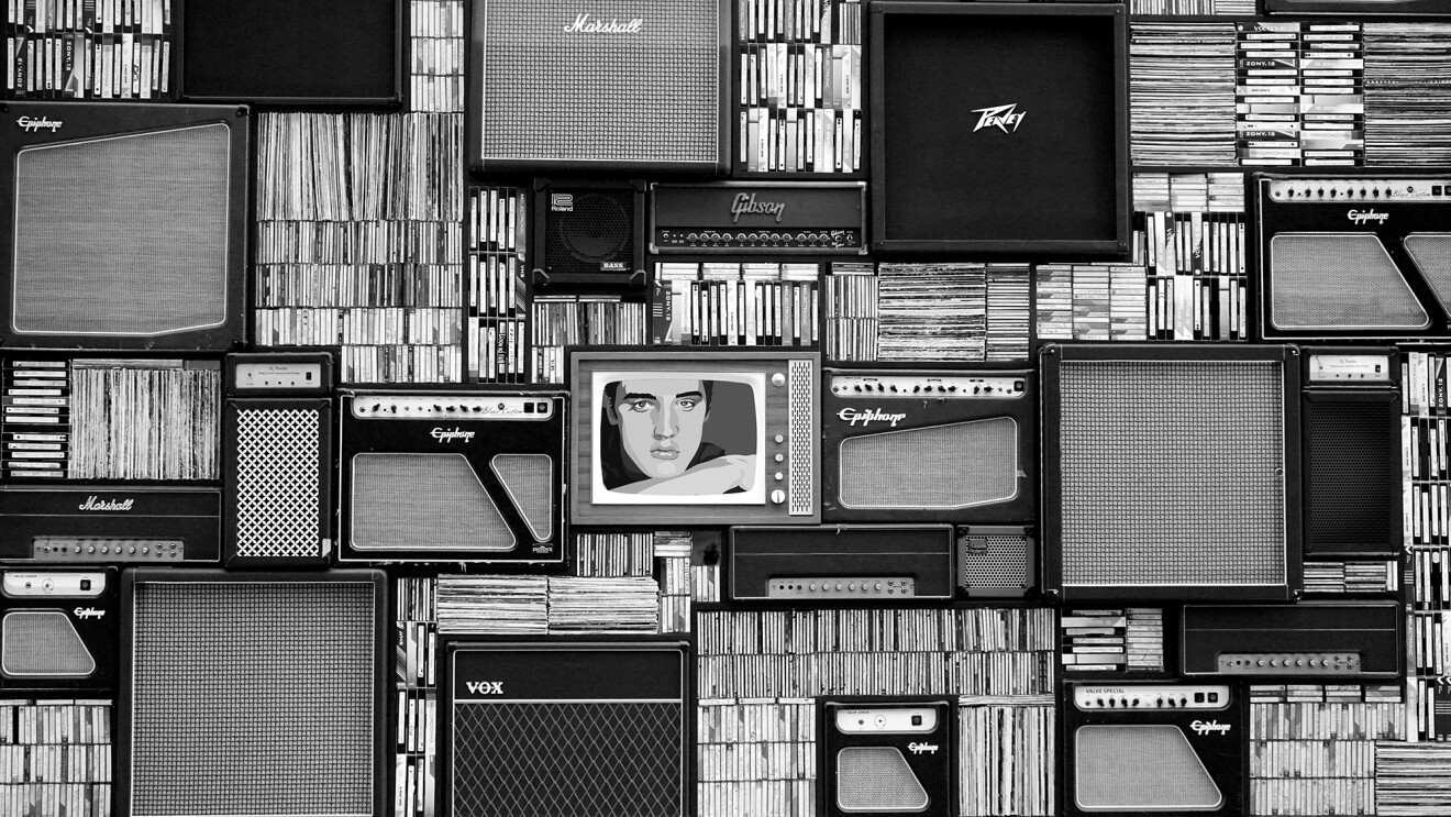 A wall of records, cassette tapes, speakers, and a photo of Elvis Presley.