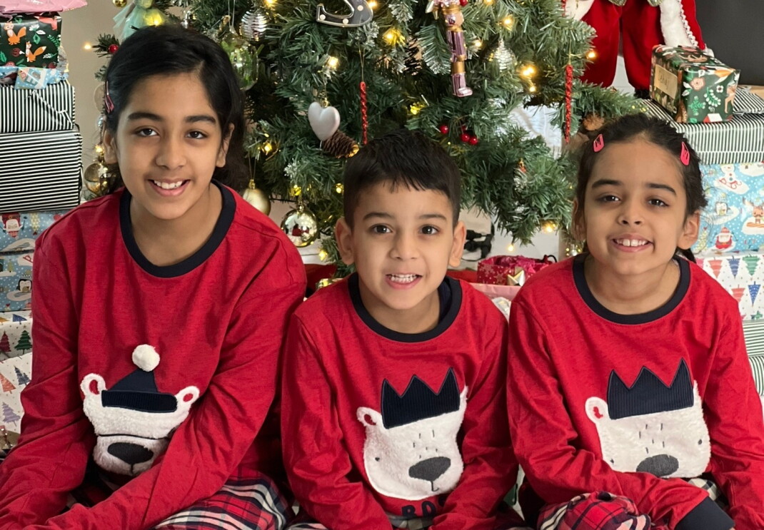 Sharon Kaur's children pictured in front of a Christmas tree