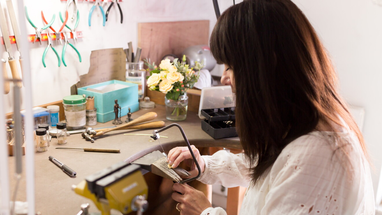 Female entrepreneur at work in her crafts studio 